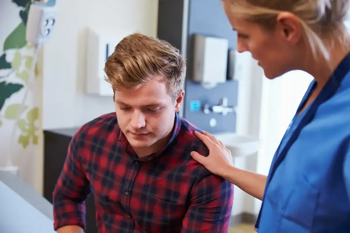 Mężczyzna rozmawiający z lekarzem o diagnozie nowotworu jądra